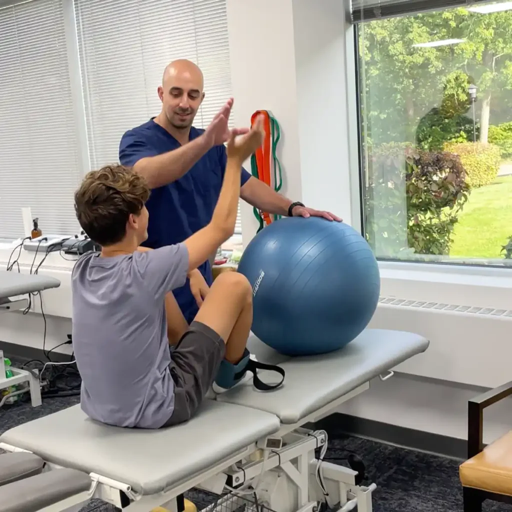 Young patient receiving physical therapy from Dr. Niko